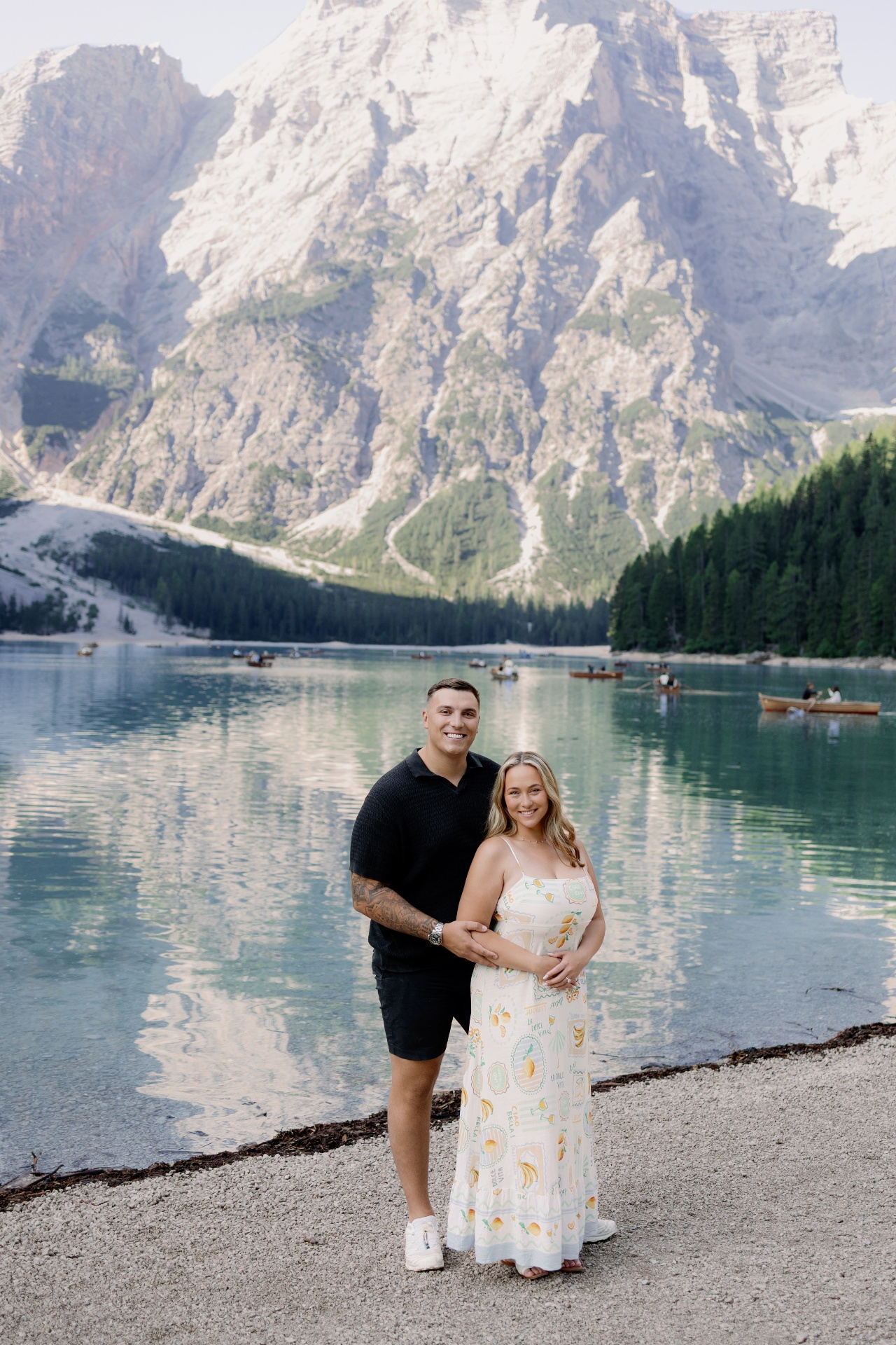 Victoria and Jamie together beside the still turquoise water of Lago di Braies