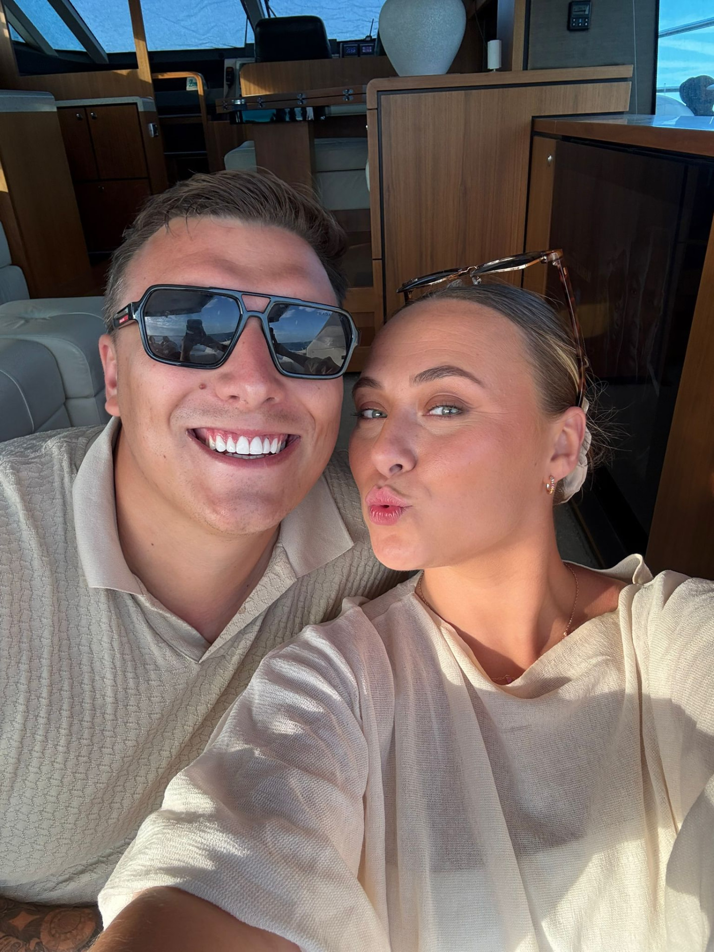 Victoria and Jamie pulling faces for a selfie on a boat