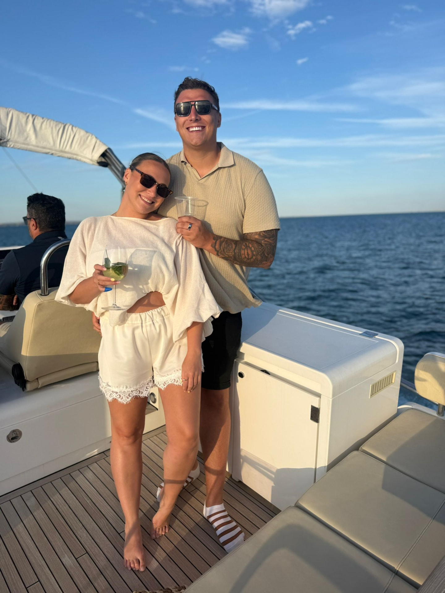 Victoria and Jamie with drinks on a boat