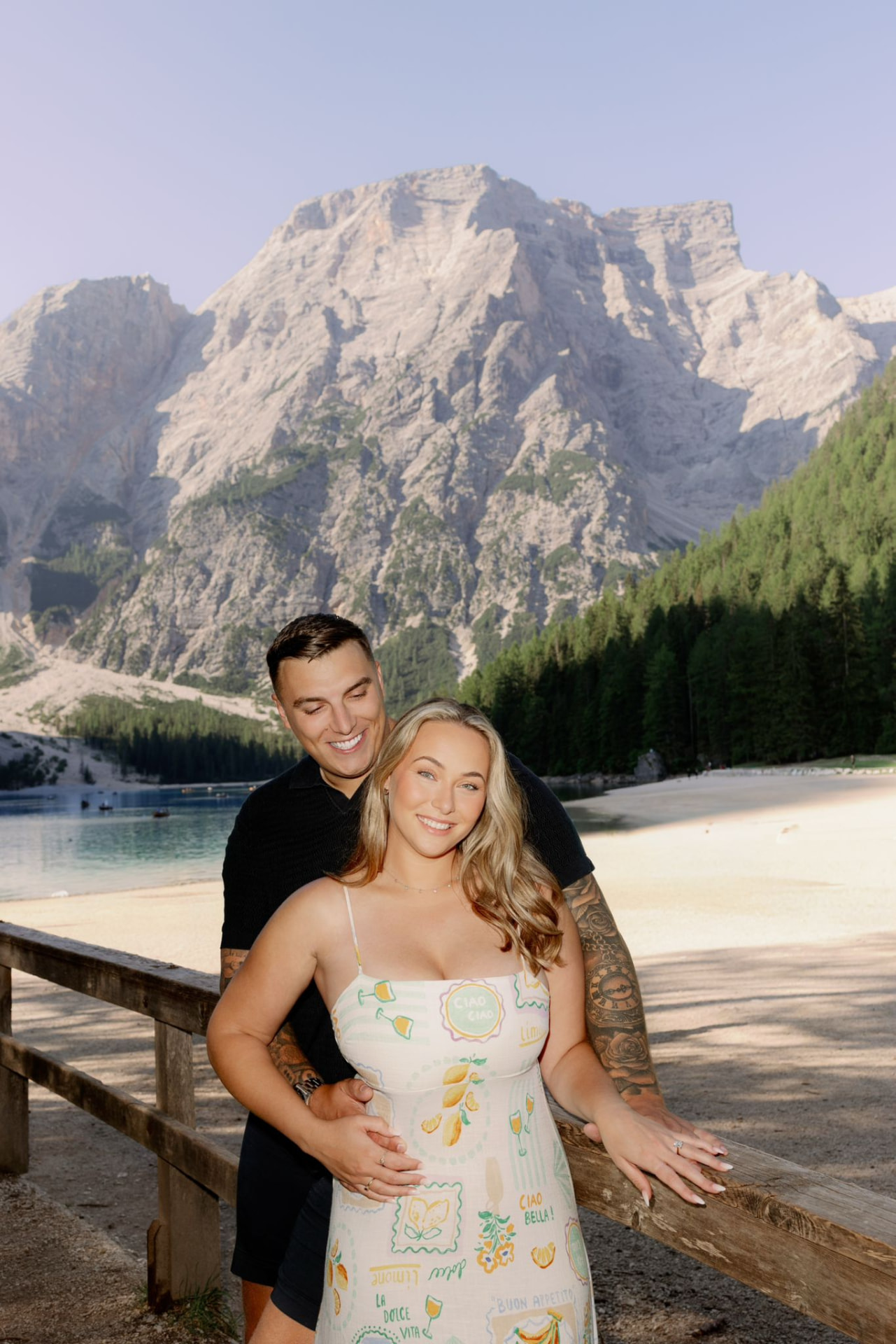 Victoria and Jamie beside Lago di Braies with the mountains behind them